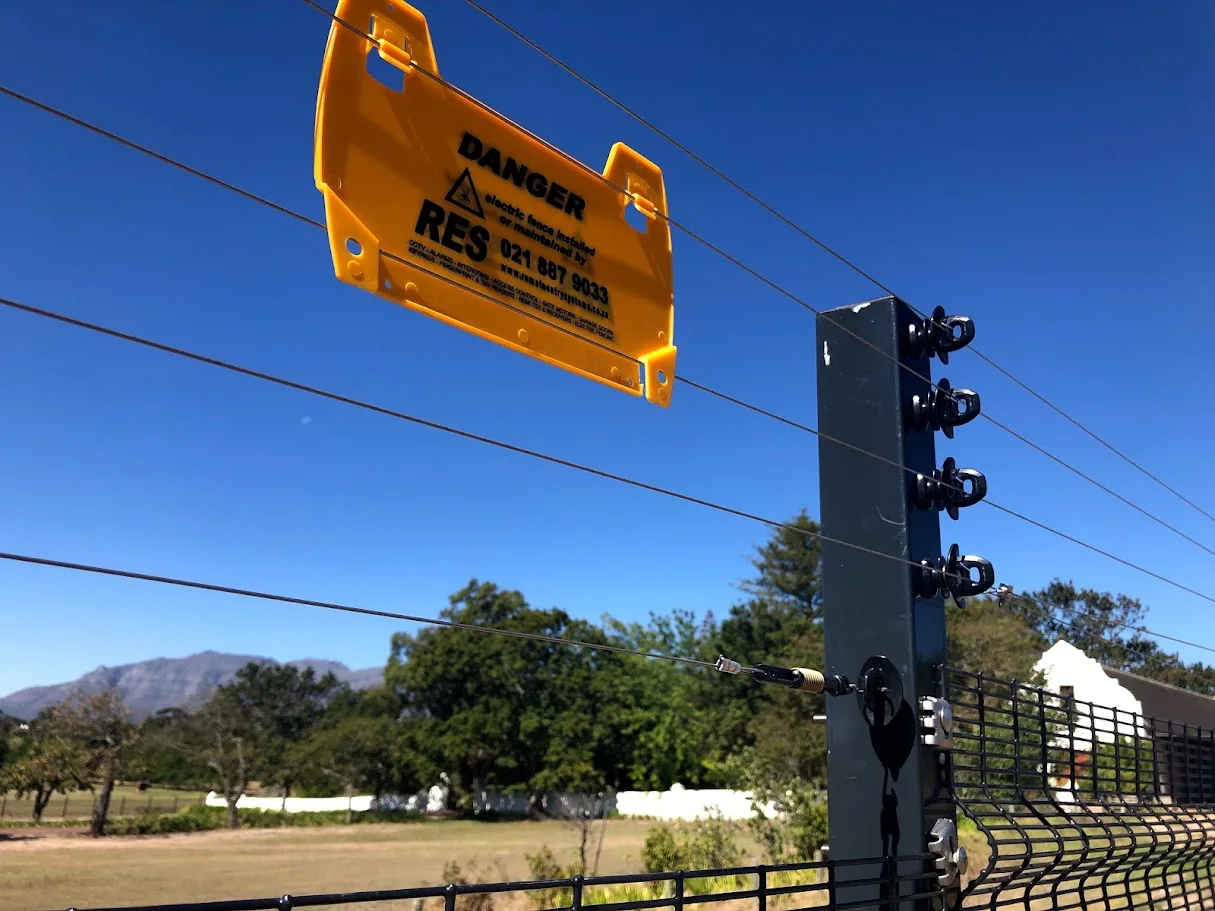 Perimeter electric fence and warning sign