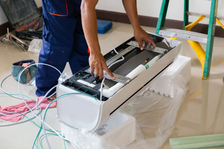 Air conditioning technician inspecting an indoor unit